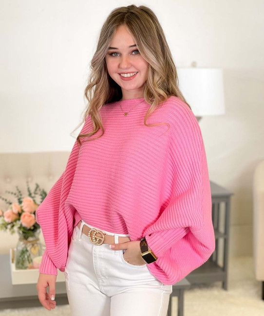 Young woman wearing a pink, oversized sweater