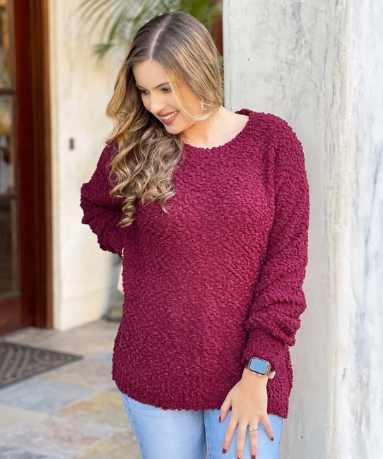 Woman wearing a burgundy sweater