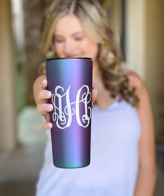 A young woman holding a tumbler