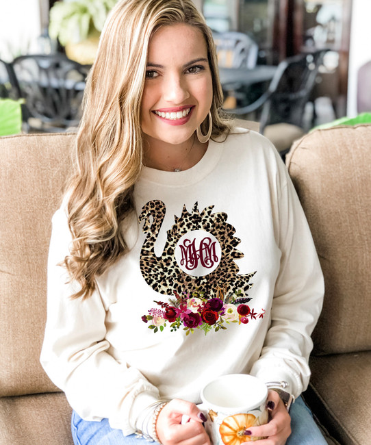 A young woman wearing a shirt and holding a mug